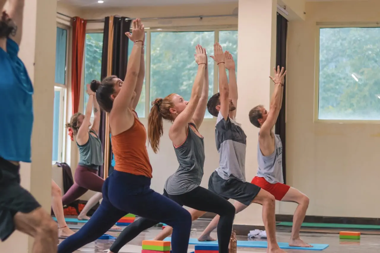 yoga students practicing yoga inside yogshala